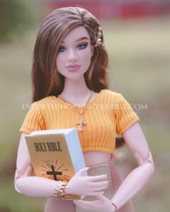 Barbie doll holding a bible